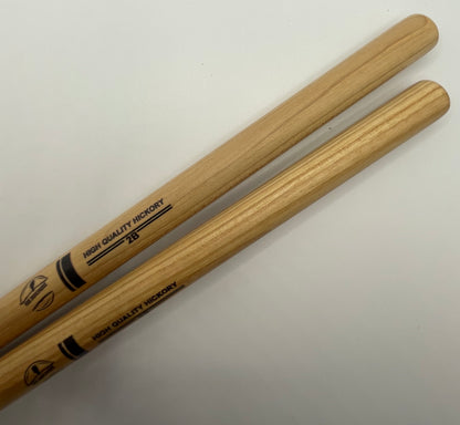 Two wooden drumsticks with branding on a white background