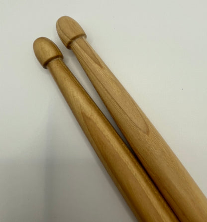 Two wooden drumsticks on a white background