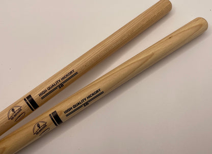 Two wooden drumsticks with 'High Quality Hickory' text on a light background