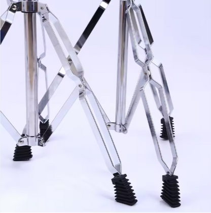 Close-up of a metallic tripod leg with rubber feet on a white background