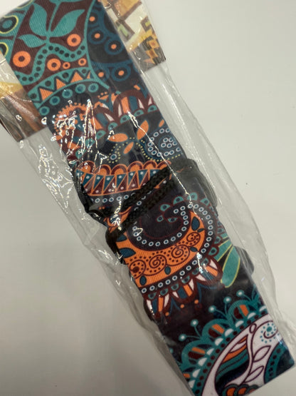 Decorative guitar strap with colorful pattern in packaging on a white background