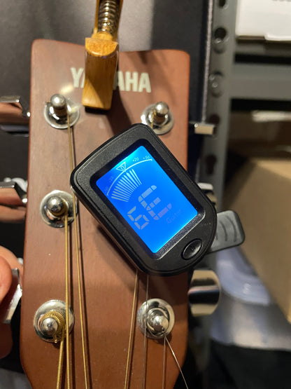 Digital tuner on a guitar headstock with Yamaha branding