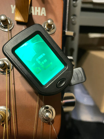 Digital tuner on a guitar headstock with Yamaha branding