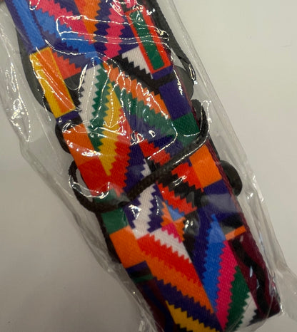 Colourful patterned guitar strap in packaging on a white background