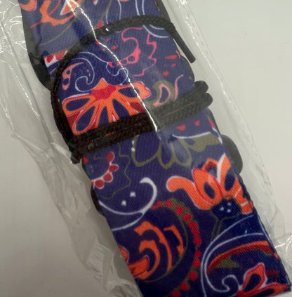 Colourful patterned guitar strap with black string on a white background
